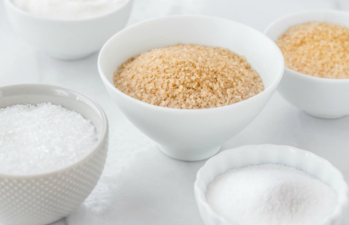 An image comparing granulated sugar and powdered sugar to visually represent the fine texture of powdered sugar for precise control.