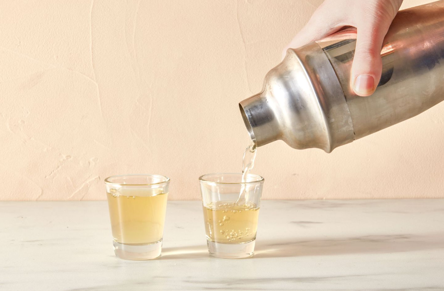 Image of a person enjoying a homemade green tea shot in a relaxed setting.